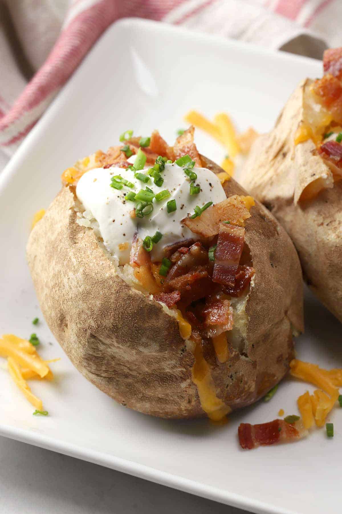 Close up of toppings on a loaded baked potato.