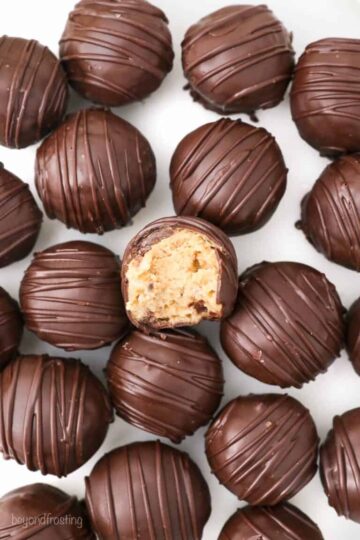 Chocolate covered peanut butter candies on parchment paper.