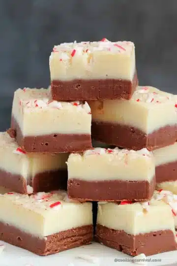 A stack of fudge squares on a white plate.