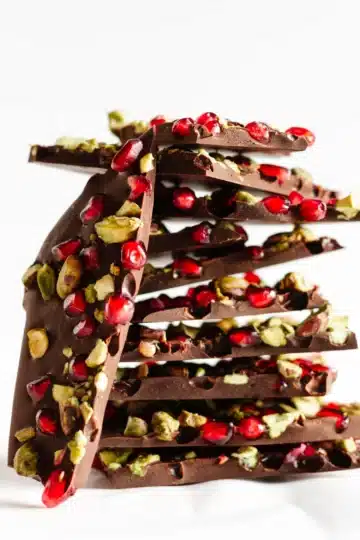 A stack of chocolate bark pieces on a white cloth.