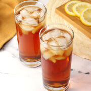 Two glasses of sweet tea filled with ice.