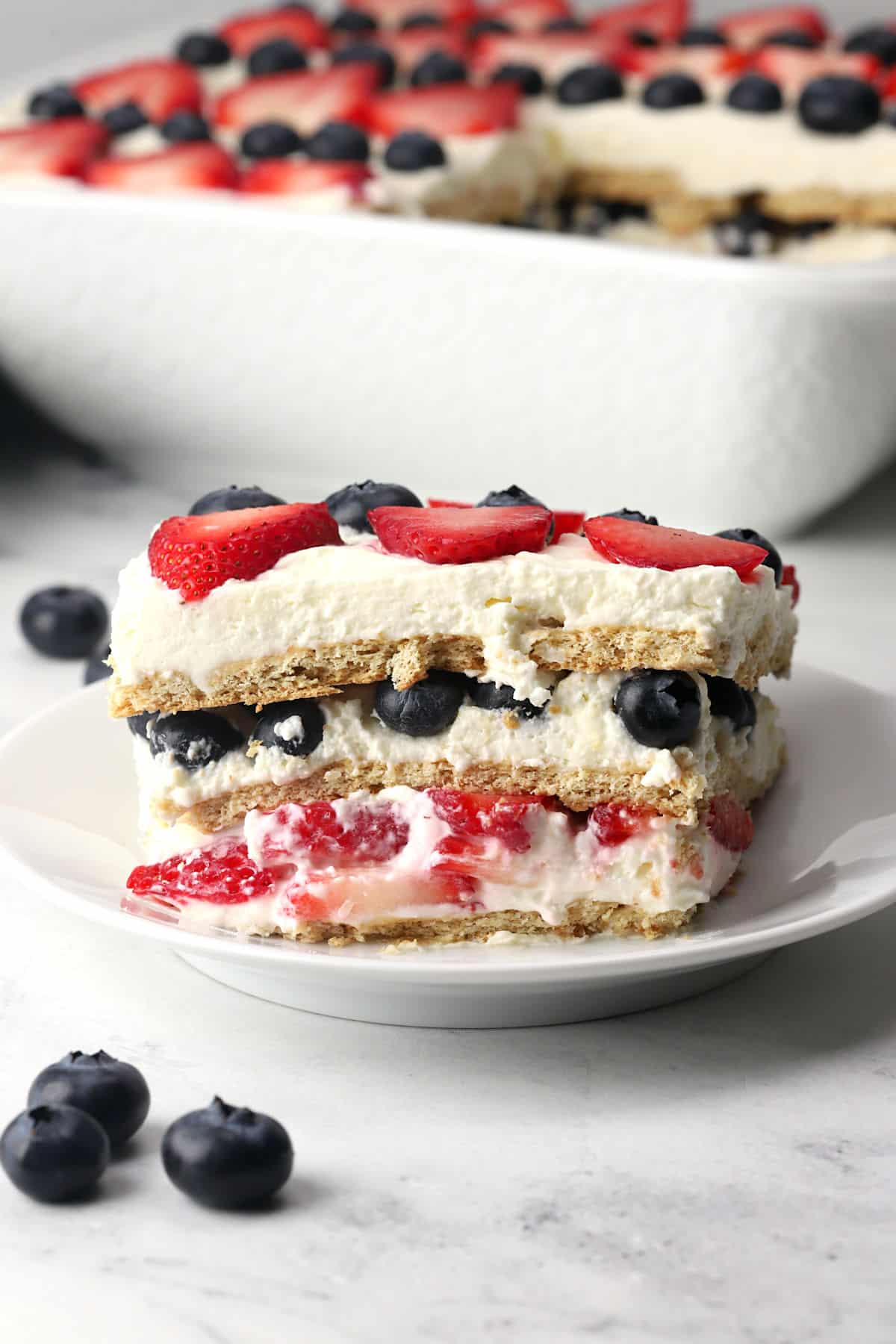 A slice of summer berry icebox cake on a serving plate.