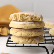 A stack of iced chai sugar cookies on a cooling rack.