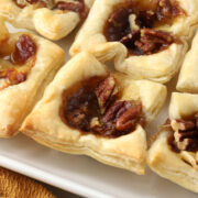 Apple butter brie bites on a serving platter.