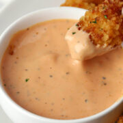 Dipping a nugget into chicken dipping sauce.