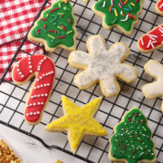 Cut out sugar cookies on a cooling rack.