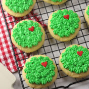 Grinch sugar cookies on a cooling rack.