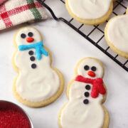 Snowman cookies on parchment paper.