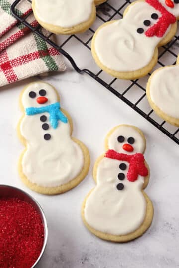 Snowman cookies on parchment paper.
