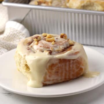 A banana bread cinnamon roll on a plate.