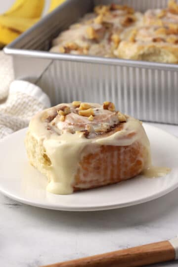 A banana bread cinnamon roll on a plate.