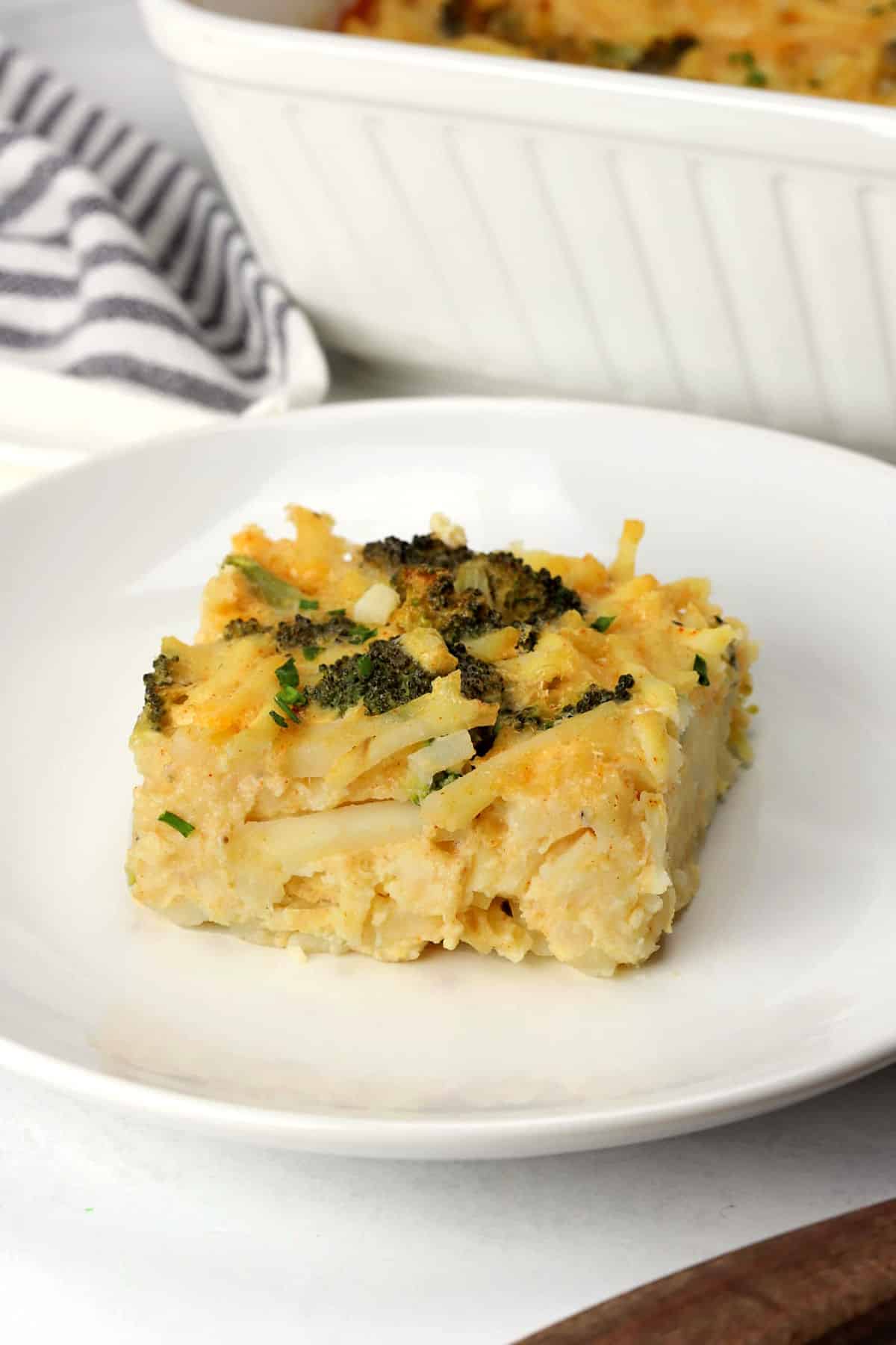 A slice of broccoli cheese breakfast casserole on a plate.