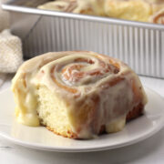 A homemade cinnamon roll on a plate.