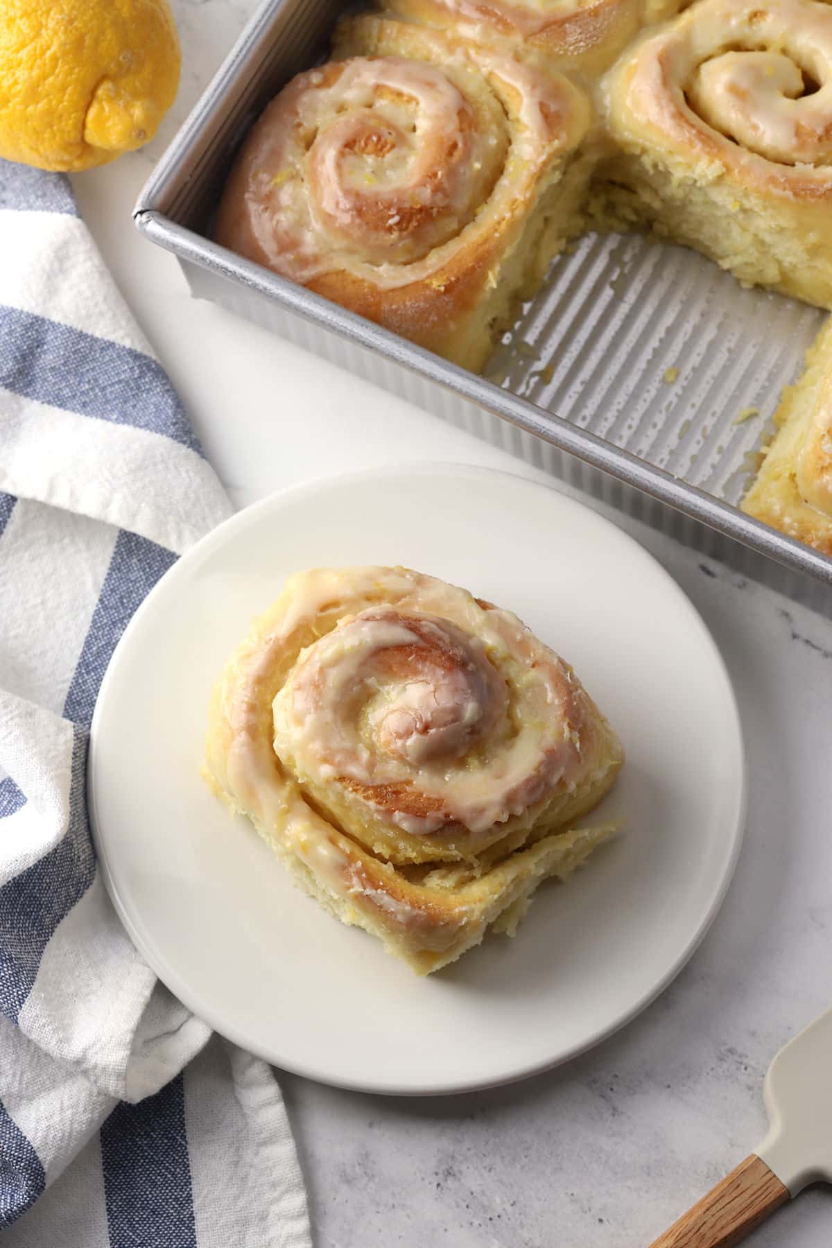 A lemon sweet roll on a plate.