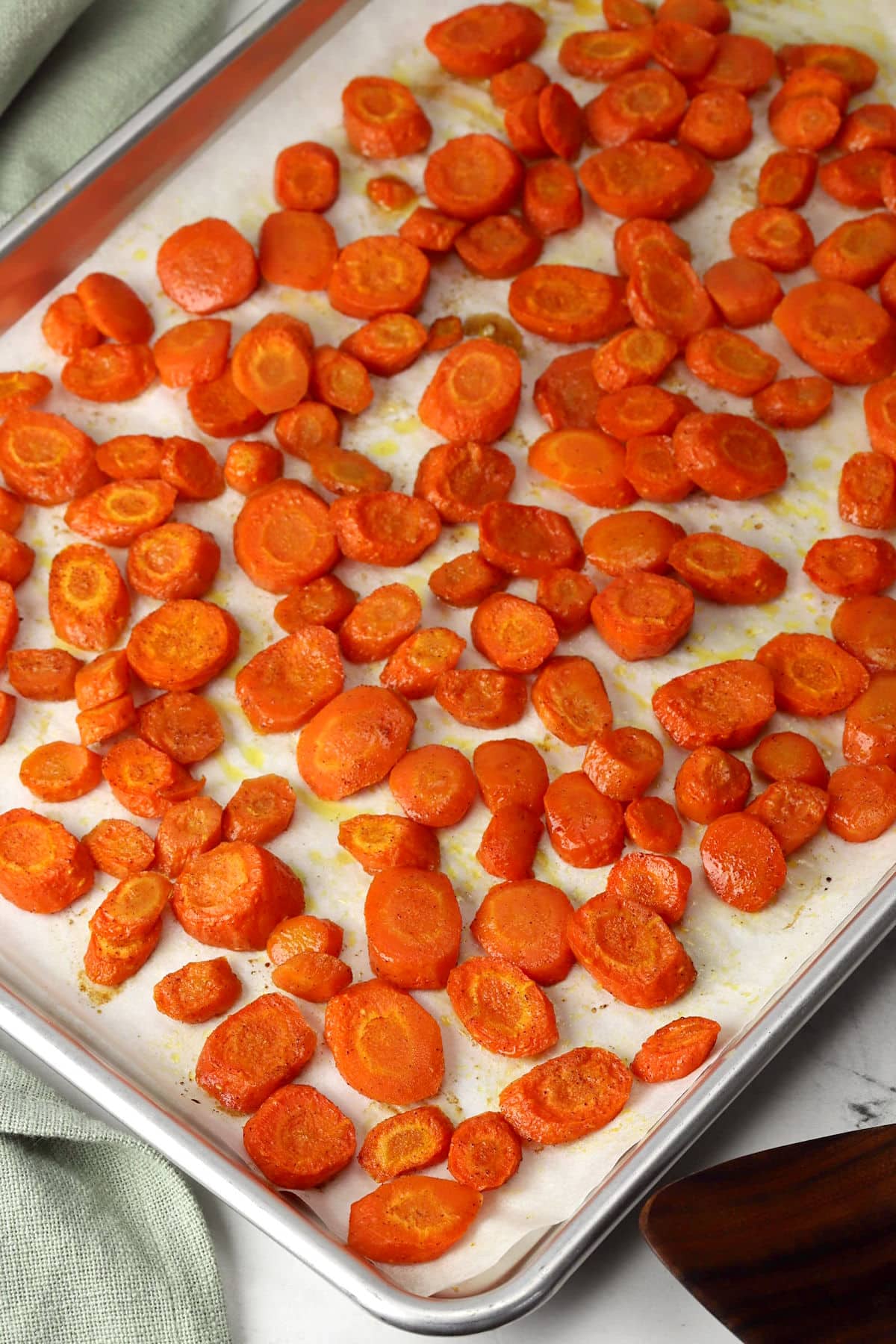 Brown sugar roasted carrots on a baking tray.