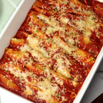 Cheese stuffed shells in a casserole dish.