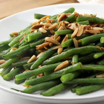 Green beans on a plate with almonds.
