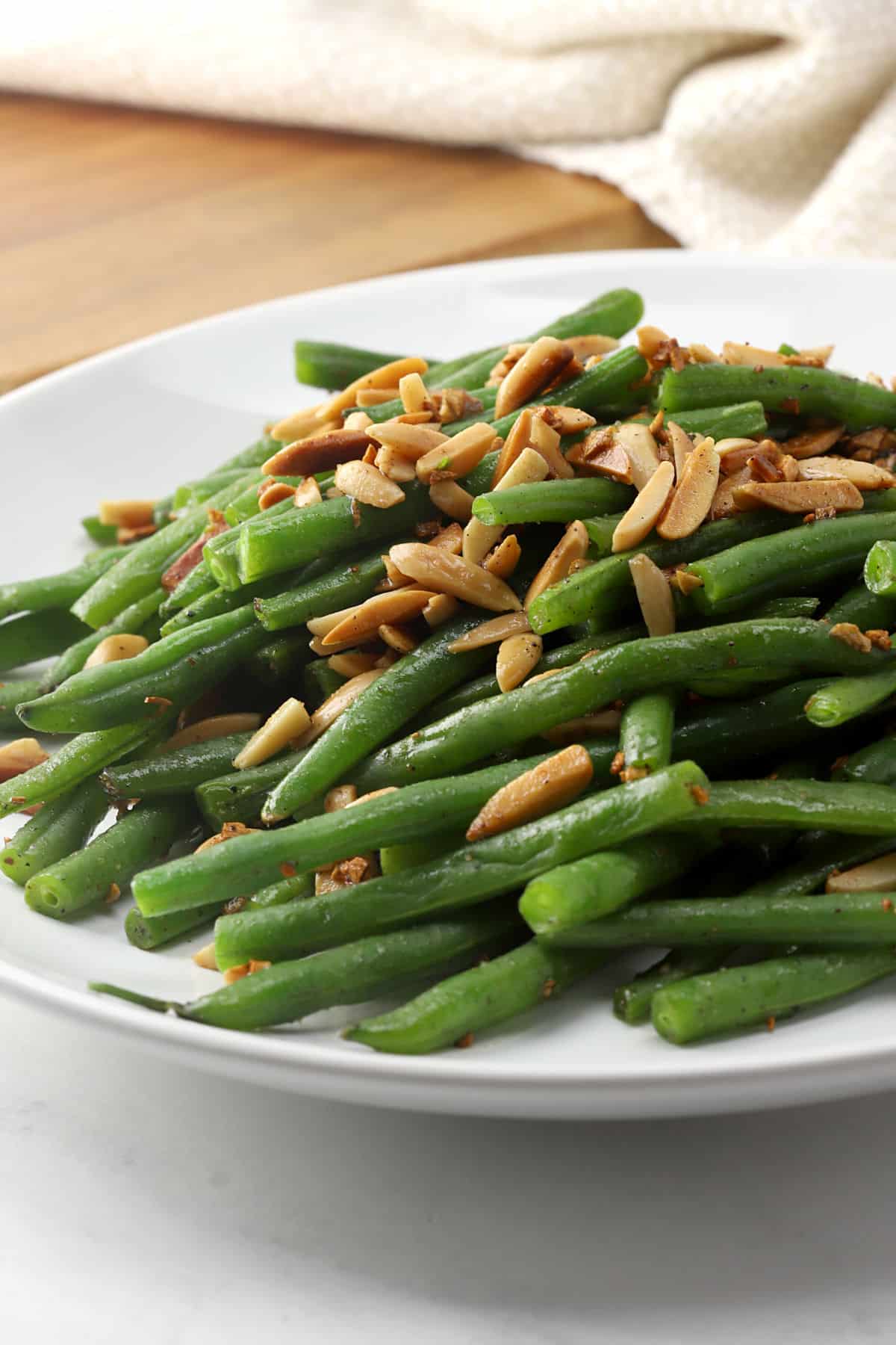 Green beans on a plate with almonds.