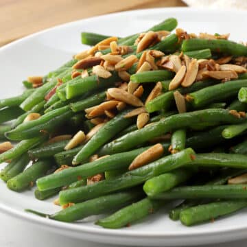 Green beans on a plate with almonds.