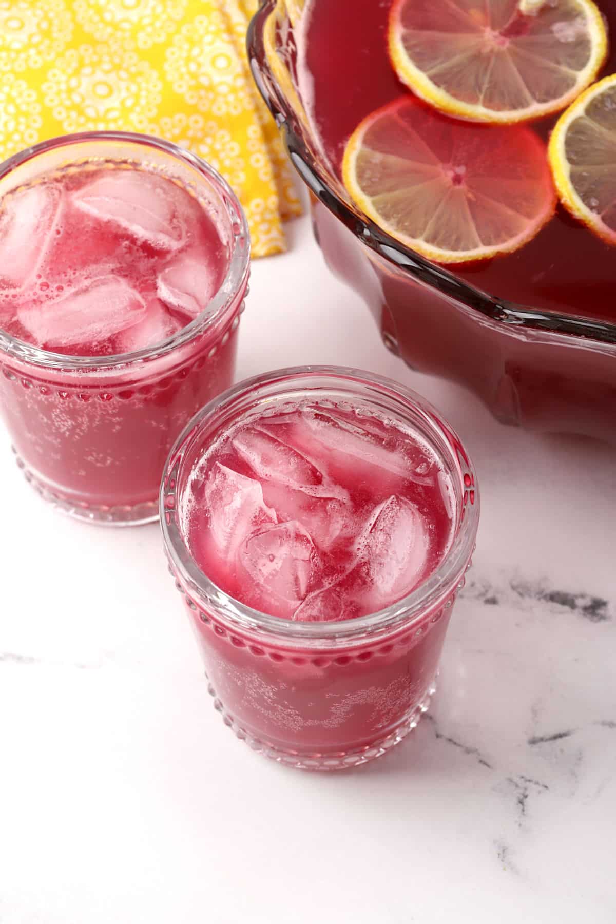 Two glasses of punch with ice.