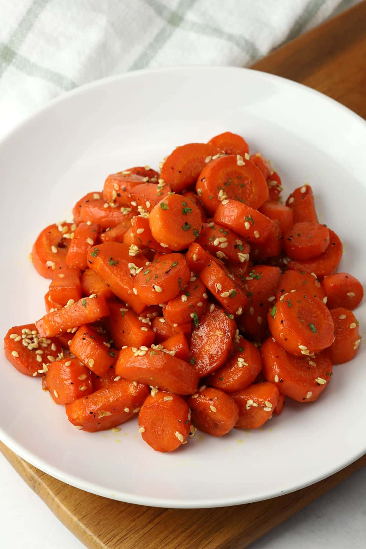 A serving plate filled with glazed carrots.