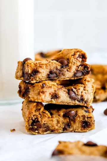 A stack of blondies on parchment paper.