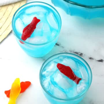 Two glasses of punch with candy fish as garnish.