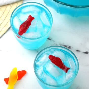Two glasses of punch with candy fish as garnish.