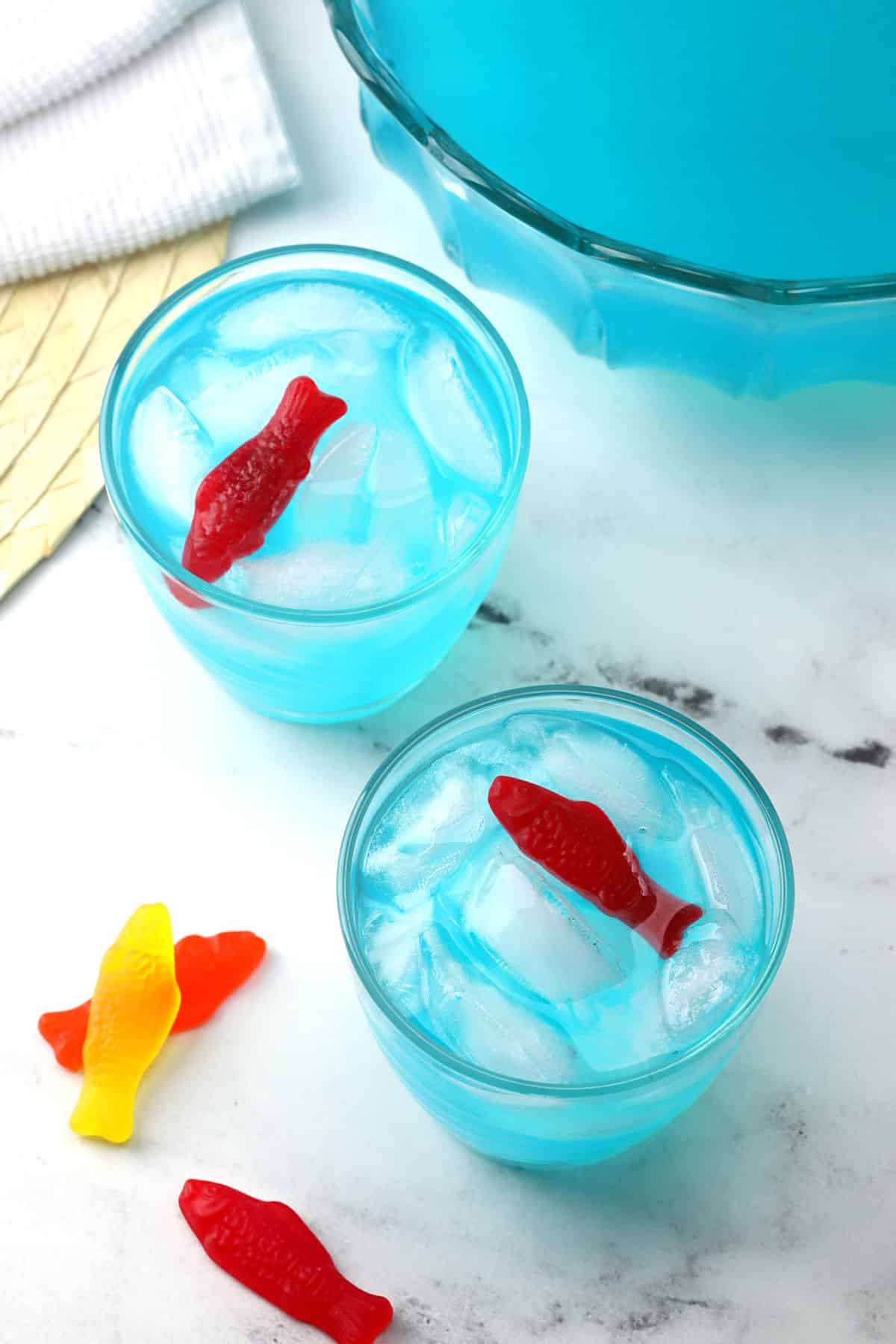 Two glasses of punch with candy fish as garnish.