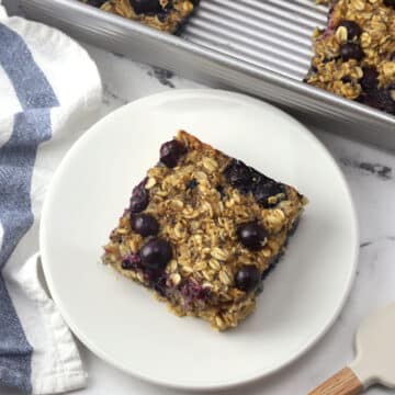 A slice of blueberry baked oatmeal on a plate.