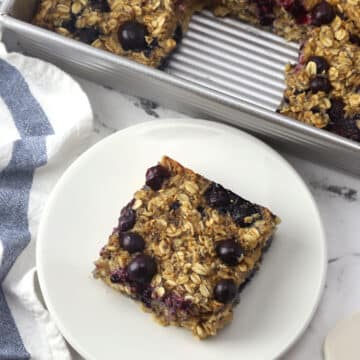 A slice of blueberry baked oatmeal on a plate.