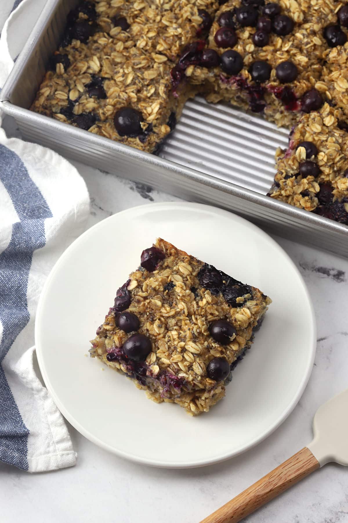 A slice of blueberry baked oatmeal on a plate.