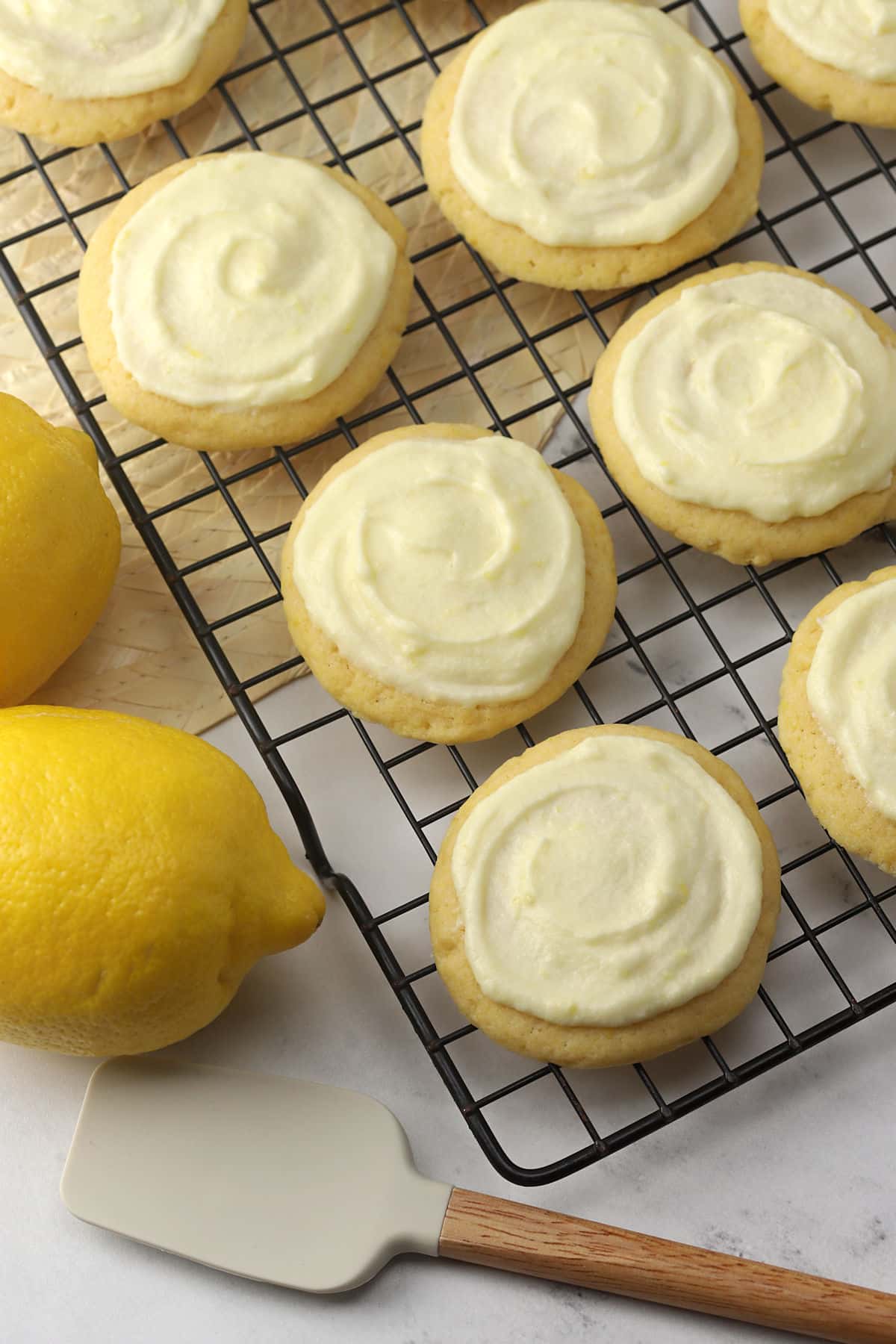 Cookies on a cooling rack with lemons nearby.