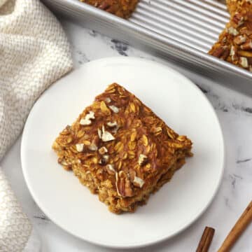 A square of pumpkin baked oatmeal on a plate.