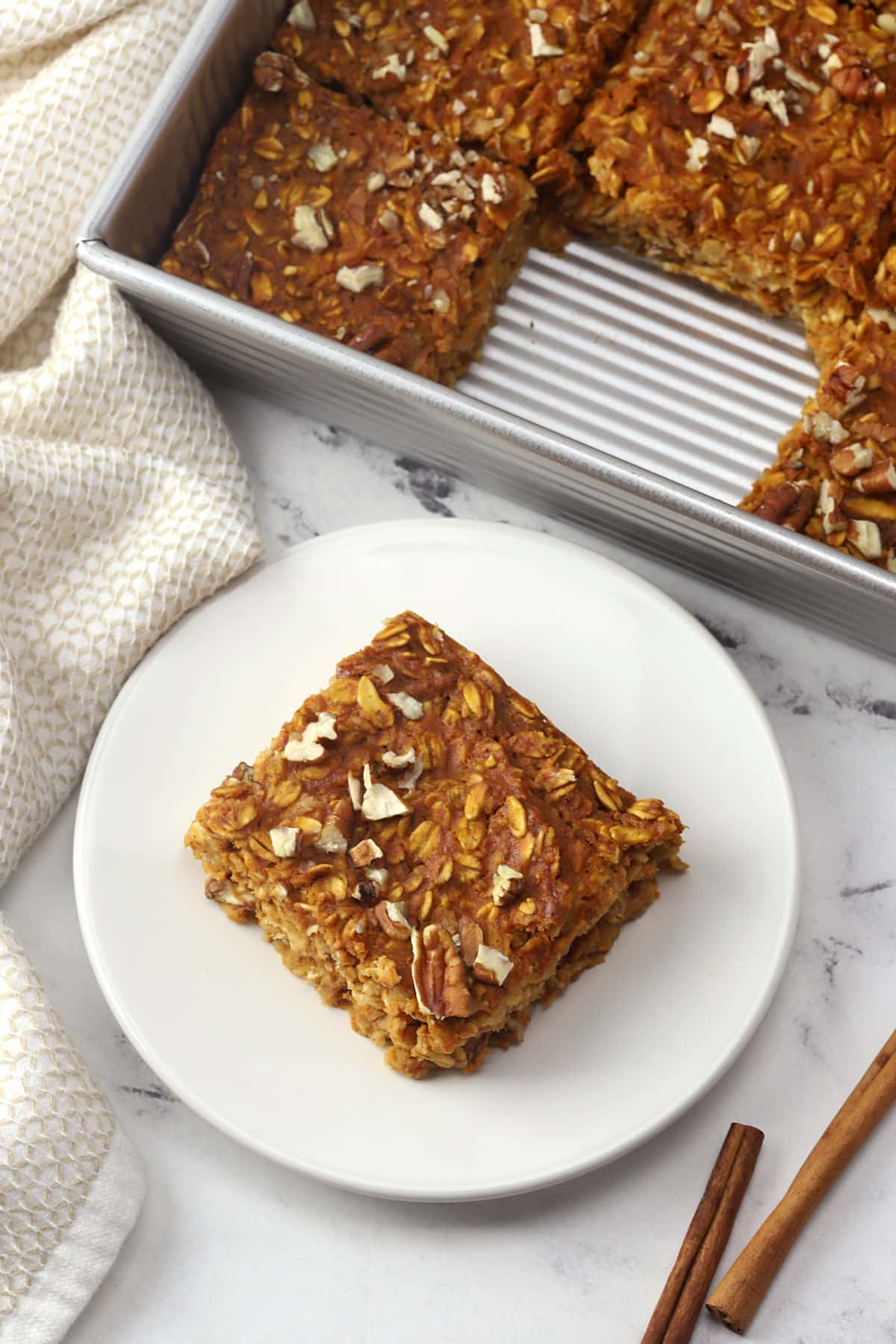 A square of pumpkin baked oatmeal on a plate.