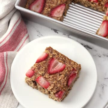 A square of strawberry baked oatmeal on a plate.