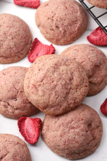 Strawberry sugar cookie stacked on a countertop.