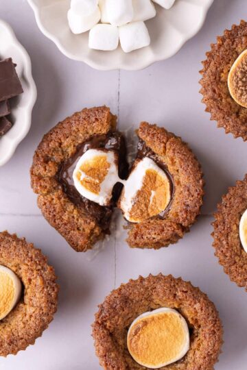 A split cookie cup filled with melted chocolate and toasted marshmallow.