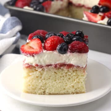 A slice of sheet cake with layered topping on a small plate with a fork.
