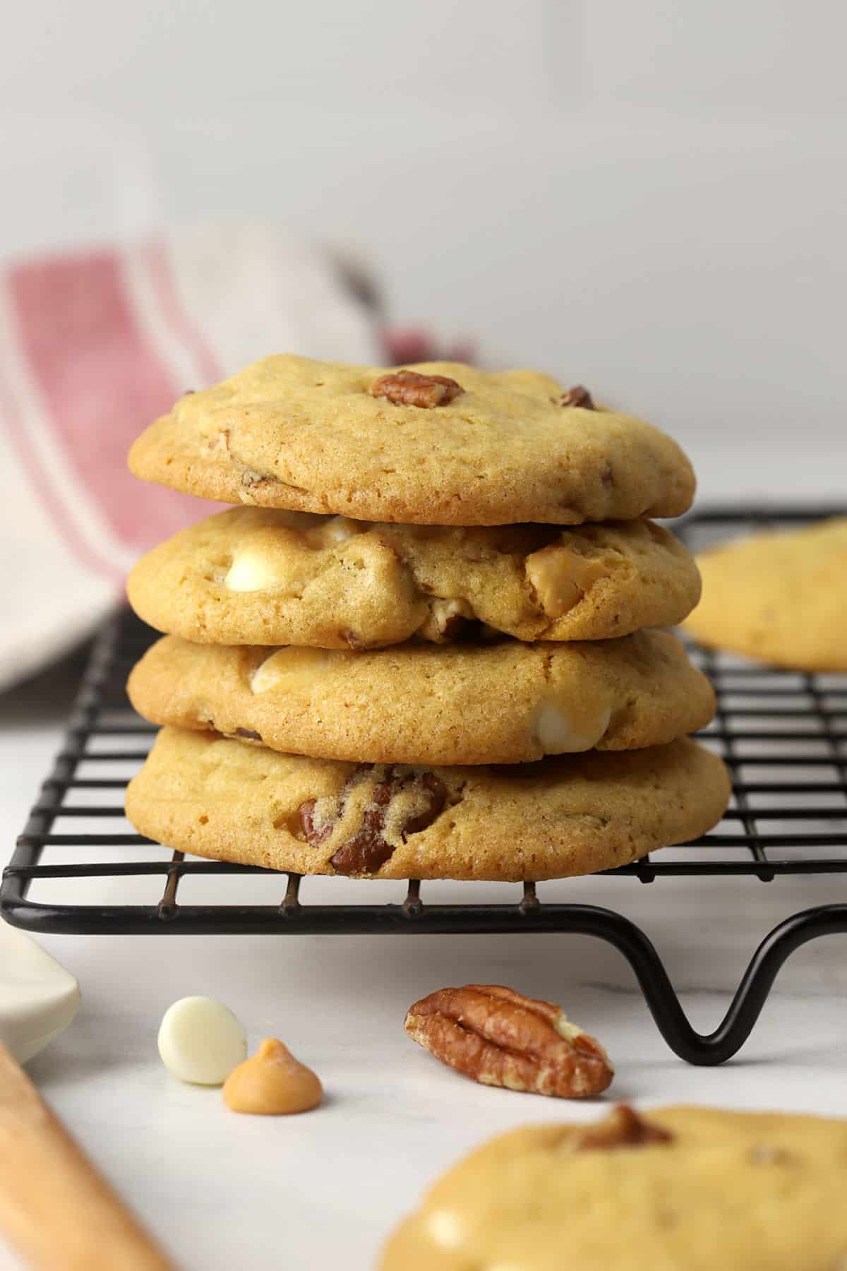 A stack of butter pecan cookies on a cooling rack.