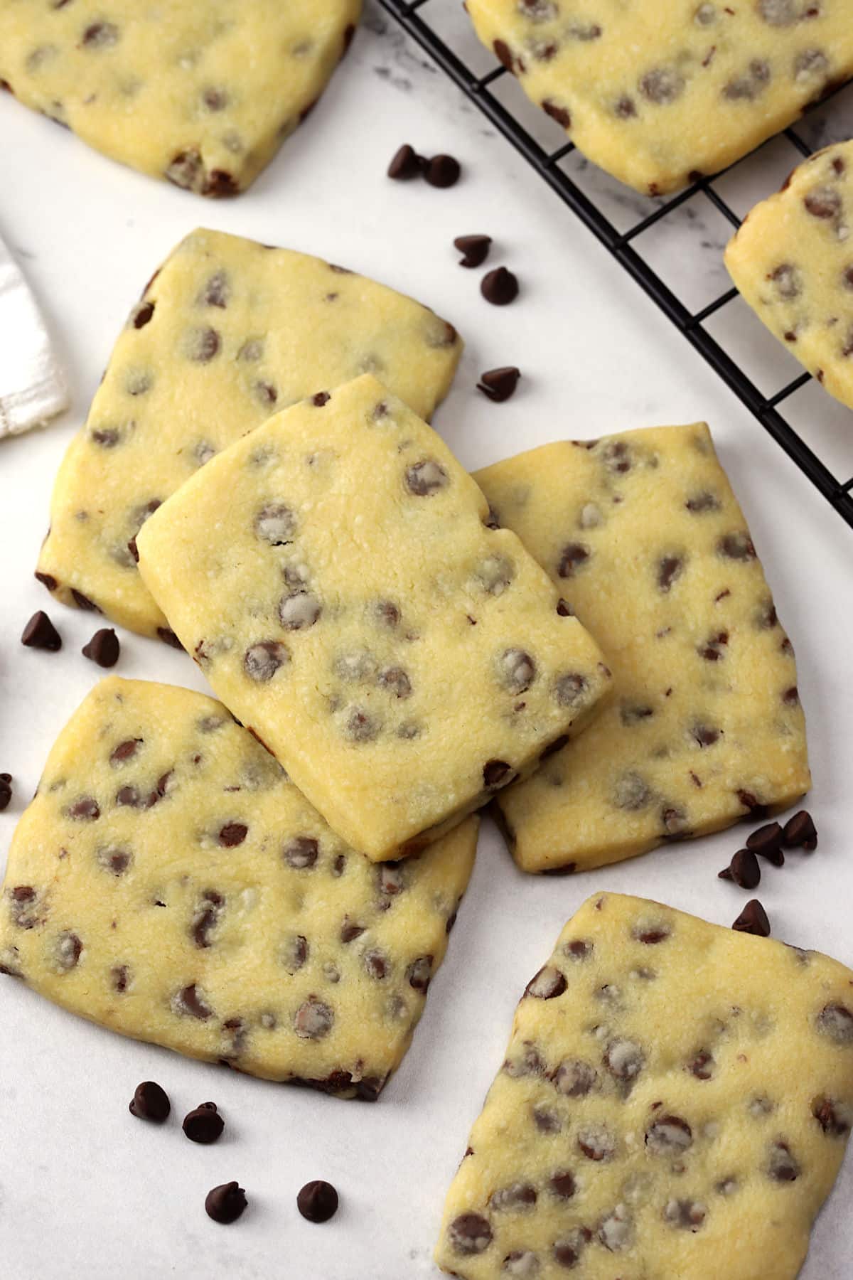 Chocolate chip shortbread cookies on a marble counter top.