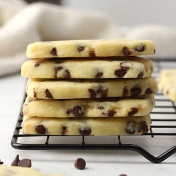 A stack of chocolate chip shortbread cookies on a counter top.