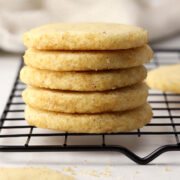 A stack of heidesand brown butter cookies on a cooling rack.