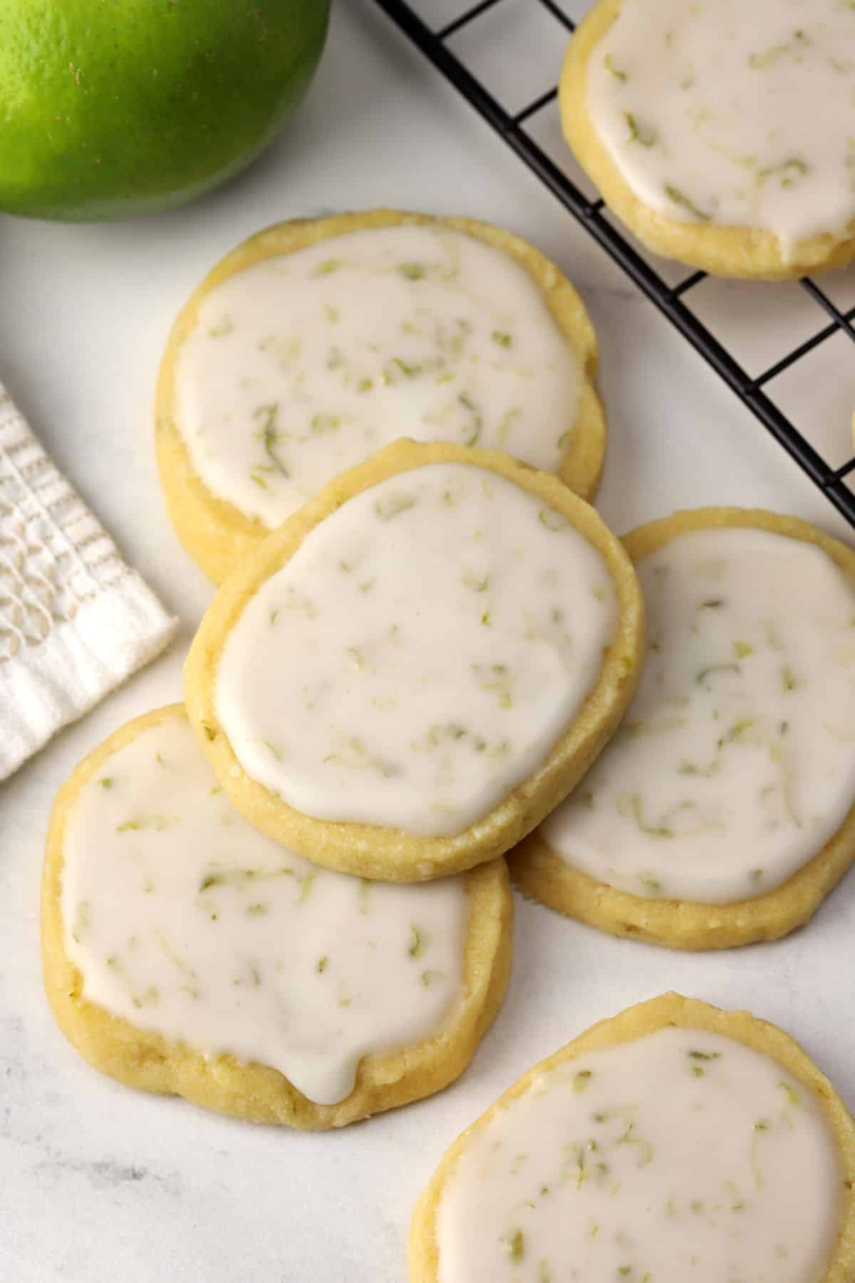 Iced lime cookies laying on a marble counter top.