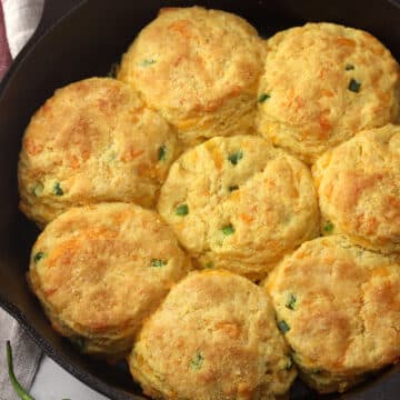 A cast iron pan filled with jalapeno cheddar cornmeal biscuits.