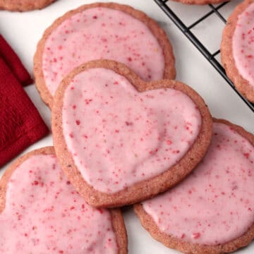Strawberry sugar cookies on a marble counter top.