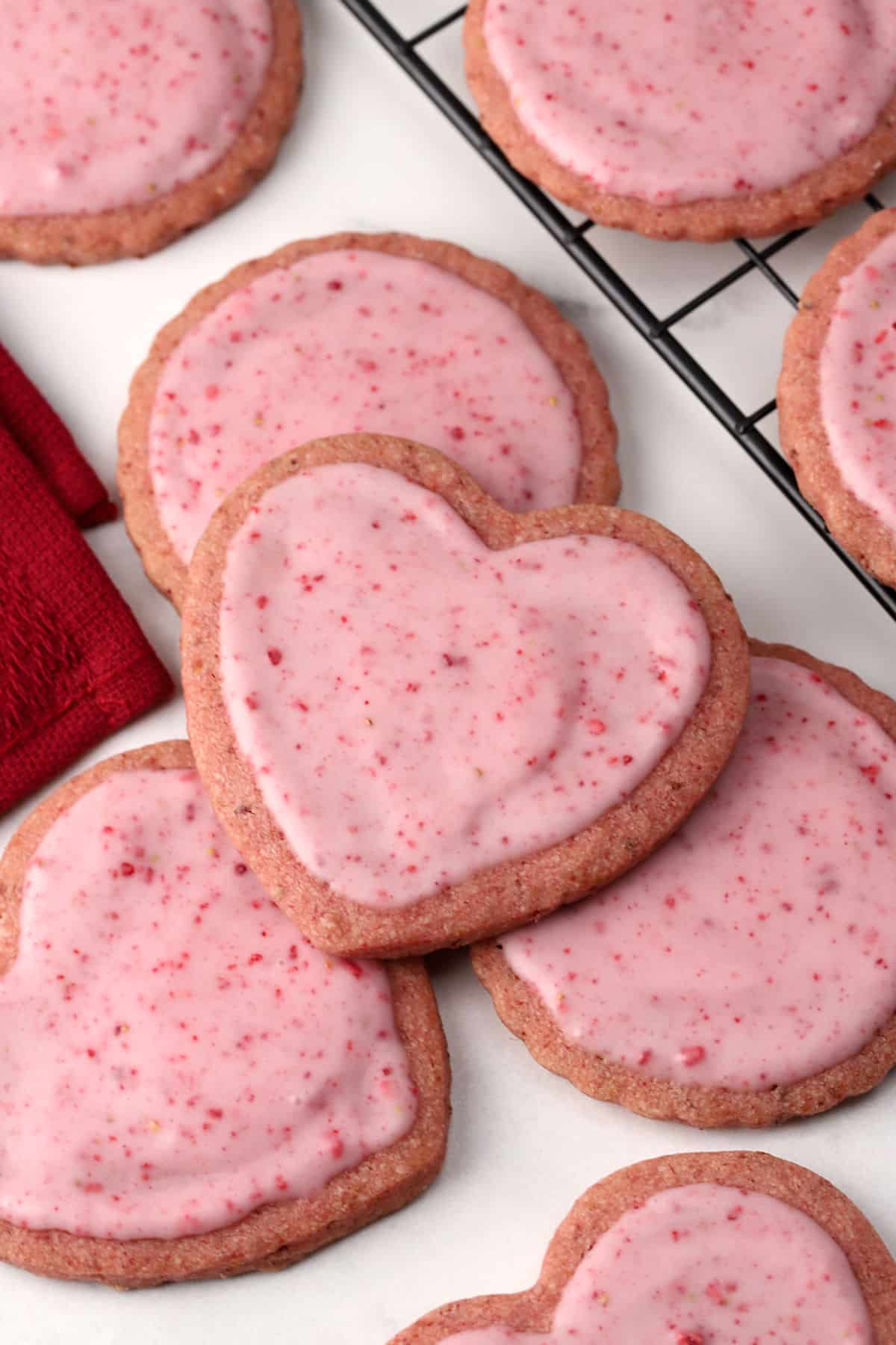 Strawberry sugar cookies on a marble counter top.