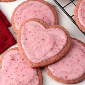 Strawberry sugar cookies on a marble counter top.