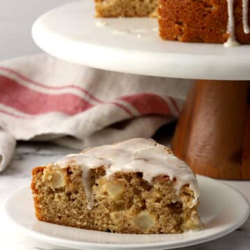 A slice of apple fritter cake on a small plate.