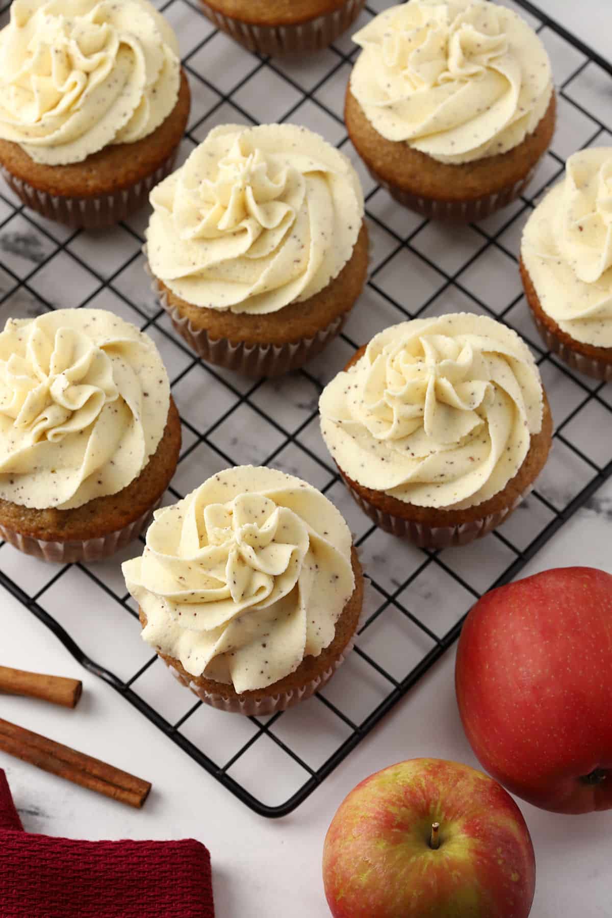 Frosted cupcakes on a cooling rack.